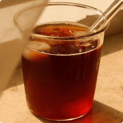 Cup of Indonesia Manis coffee with vibrant flavors of pineapple, soft orange, and red fruit